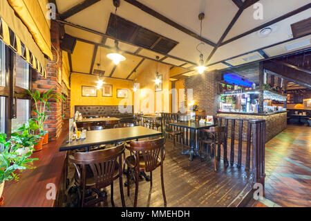 MOSCOW - AUGUST 2014: The interior of the beer bar restaurant 'PIV&CO'. Wooden furnished hall Stock Photo