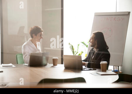 Friendly smiling businessman and businesswoman enjoying conversa Stock Photo