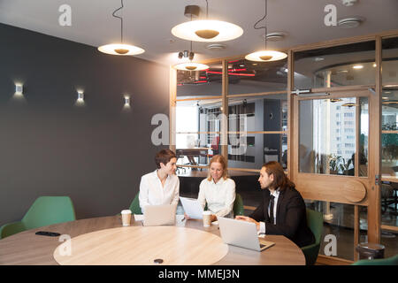 Businesspeople having discussion at team meeting in modern offic Stock Photo