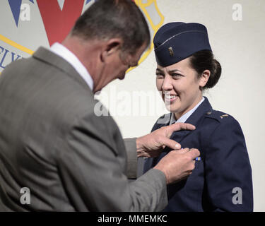 2nd Lt. Katherine Dixon has her Air Force Pilot badge pinned on by her father, Peter Dixon, at Vance Air Force Base, Oklahoma, Oct. 27. (U.S. Air Force photo by David Poe) Stock Photo