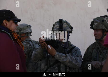 U.S. Army Soldiers of the 1st Brigade Combat Team, 3rd Infantry Division are active-duty personnel within a combined arms infantry formation of the United States Army. The archival image documents biometric identification training using a fingerprint scanner during Decisive Action Rotation 18-01 at the National Training Center, Fort Irwin, California, on October 22, 2017. Stock Photo