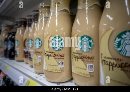 Bottles of Starbucks Frappuccino coffee are seen on a supermarket shelf in New York on Friday, May 4, 2018. NestlŽ is reported to be in talks to purchase Starbucks' grocery business. The units that sell beans and drinks in supermarkets and groceries are involved and not any of the stores. NestlŽ is the world's largest packaged food company. (© Richard B. Levine) Stock Photo