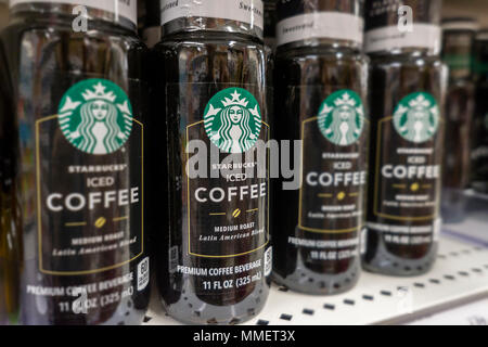Bottles of Starbucks iced coffee are seen on a supermarket shelf in New York on Friday, May 4, 2018. NestlŽ is reported to be in talks to purchase Starbucks' grocery business. The units that sell beans and drinks in supermarkets and groceries are involved and not any of the stores. NestlŽ is the world's largest packaged food company. (© Richard B. Levine) Stock Photo