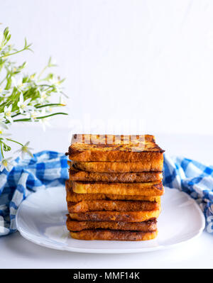 fried French toast on a ceramic white plate, French toast Stock Photo