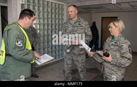 U.S. Air Force Col. Matthew Leard, 60th Air Mobility Wing vice commander, and Chief Master Sgt. Erika Scofield, 60th Mission Support Group superintendent, are briefed by James Frazier, 60th Security Forces Squadron, on what to expect during 60th SFS Defender Annual Refresher crucible training, date/place. The teams of specially trained security forces personnel are dedicated to providing security for terrorist and criminal threat areas. (U.S. Air Force photo by Heide Couch) Stock Photo