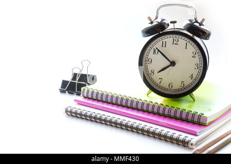 Colorful school supplies, book and alarm clock on white. Close up. Back to school. Stock Photo