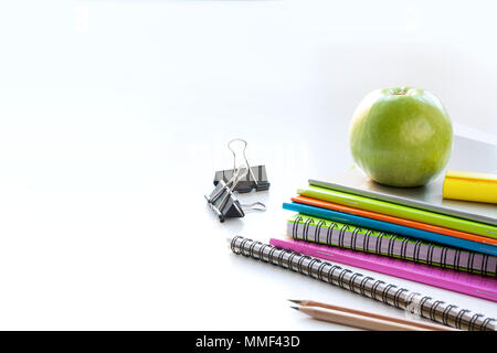 Colorful school supplies, book, apple on white. Close up. Back to school. Stock Photo