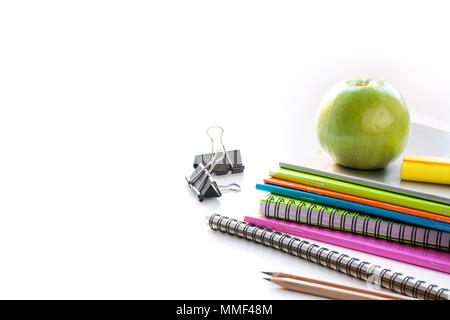 Colorful school supplies, book, apple on white. Close up. Back to school. Stock Photo