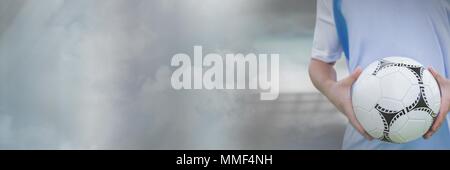 Soccer player on grass with football in stadium Stock Photo