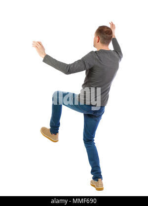 Back view man Balances waving his arms. Rear view people collection. backside view of person.  Isolated over white background. The guy slipped and fel Stock Photo