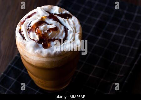 Iced Coffee Caramel Frappe / Frappuccino with Whipped Cream and Caramel Syrup. Beverage Concept. Stock Photo
