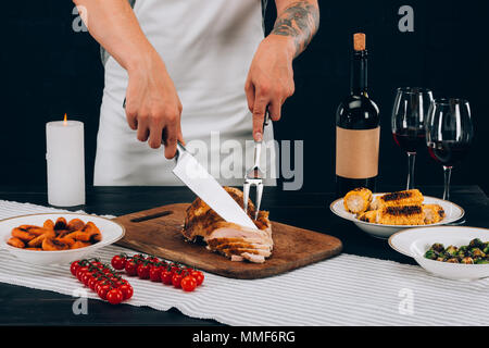 Man cutting turkey on thanksgiving day Stock Photo