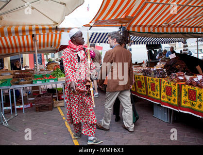 Dark-skinned souvenir seller at the market, place Cours Saleya, Nice, Côte d’Azur, Alpes-Maritimes, South France, France, Europe Stock Photo