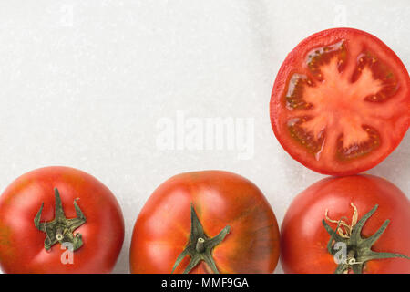 Fresh Ripe Organic Red Tomatoes Whole Halved on White Marble Stone. Italian Spanish Greek Mediterranean Cuisine. Healthy Diet Food Ingredients. Poster Stock Photo