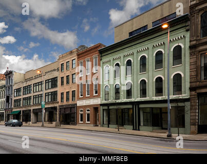 A photo of a typical small town main street in the United States of America. Features old brick buildings with specialty shops and restaurants. Stock Photo