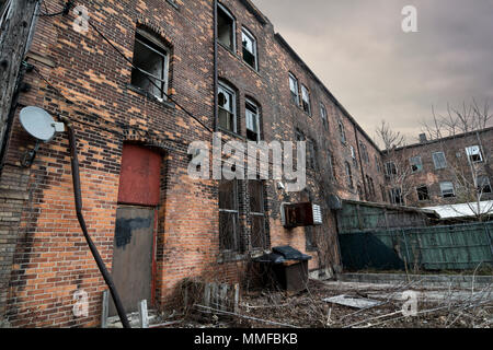 An old run down brick building in an urban setting. Sadly these are seen frequently in American cites. Stock Photo