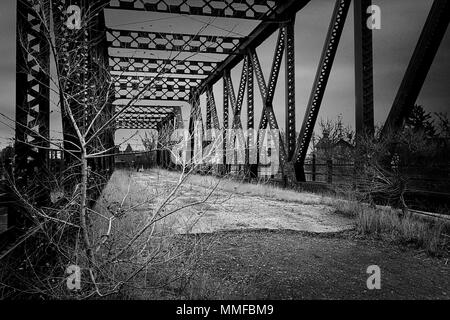 Black and white photo of an old abandoned railroad bridge in downtown Toledo Ohio. Stock Photo