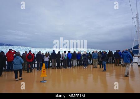 Disenchantment Bay, Alaska, USA: Passengers on the bow of a cruise ship enjoy spectacular views of the Hubbard Glacier. Stock Photo