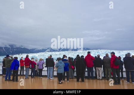 Disenchantment Bay, Alaska, USA: Passengers on the bow of a cruise ship enjoy spectacular views of the Hubbard Glacier. Stock Photo