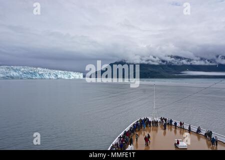 Disenchantment Bay, Alaska, USA: Passengers on the bow of a cruise ship enjoying views of the Hubbard Glacier. Stock Photo