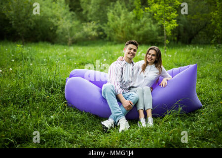 https://l450v.alamy.com/450v/mmg1j4/young-couple-spend-time-together-sitting-on-inflatable-sofa-while-resting-in-park-mmg1j4.jpg