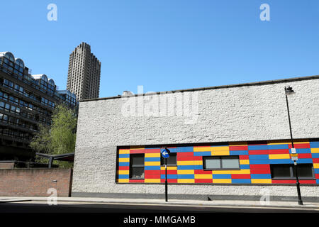 Exterior view of colourful Prior Weston Primary School building and a Barbican Estate tower in Islington in the City of London UK    KATHY DEWITT Stock Photo