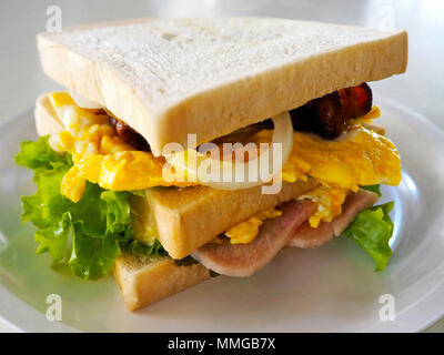 Homemade Sandwich with Ham, Bacon, Egg and Vegetables Stock Photo