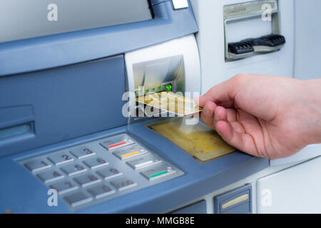 Hand inserting ATM credit card Stock Photo
