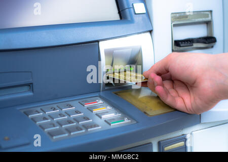 Hand inserting ATM credit card Stock Photo