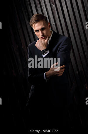 Strained And Look Confident handsome man with strained look posing in blue fashion suit ...