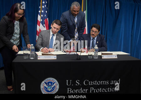 Historical photograph of CBP Commissioner Kevin K. McAleenan: U.S. Customs and Border Protection Acting Commissioner Kevin K. McAleenan, left, and DG Al Jalawi sign a customs mutual assistance agreement and memorandum of understanding between the United States and Kuwait in Washington, D.C., Sept. 7, 2017. U.S. Customs and Border Protection photo by Donna Burton Stock Photo