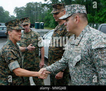 Brigadier Gen. Helen S. Pratt, the 4th Marine Logistics Group commander, greets Colombian Lt. Col. Erick Del Rio, the deputy commander of Special Purpose Marine Air-Ground Task Force - Southern Command, during her visit to Camp Lejeune, North Carolina, May 6, 2018. The SPMAGTF is preparing to deploy to Central and South America in June to conduct tailored training and engineering projects alongside security forces in these regions, and will be on standby to provide humanitarian assistance and disaster relief in the event of an emergency. (U.S. Marine Corps photo by Staff Sgt. Frans Labranche)