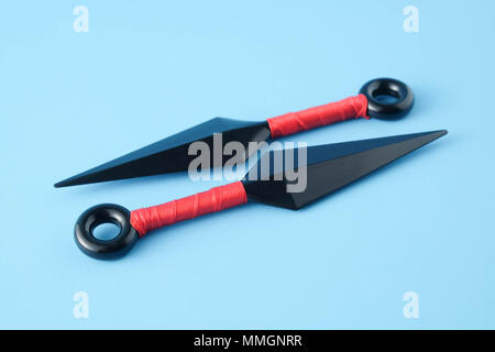 To throw ninja weapons isolated on blue paper background Stock Photo