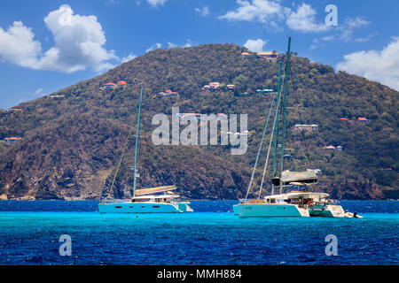 Luxury sailing catamarans near a resort island in BVI Stock Photo