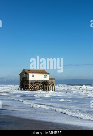 Beach house on stilts surrounded by high tide surf, Nags Head, Outer Banks, North Carolina, USA Stock Photo