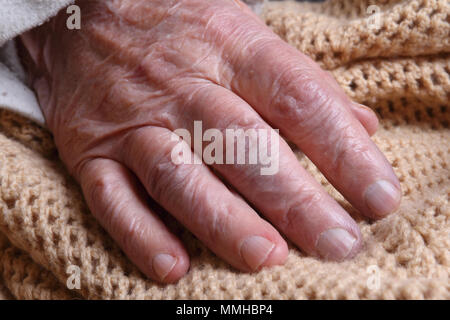 the hand of an old woman and the affection of family members Stock Photo