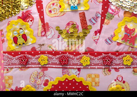 background fabric from color fabric with buttons from an owl of a cat of the girl Stock Photo