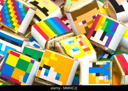 background from the bright color chocolates decorated with multi-colored drawings Stock Photo