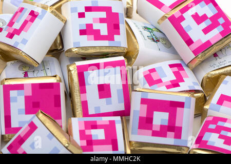 background from the bright color chocolates decorated with multi-colored letters Stock Photo