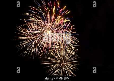 Colorful multi-colored fireworks, salute on the background of the black sky on holiday Stock Photo