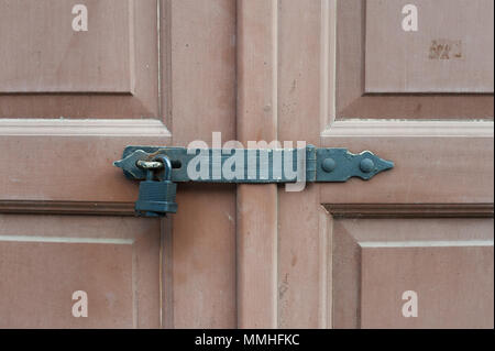 Locked wooden doors with black metal lock Stock Photo