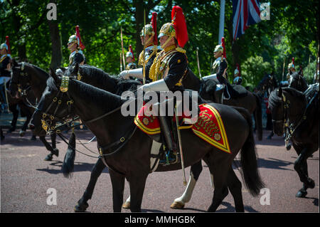 LONDON - JUNE 17, 2017: Royal guards on horseback dressed in ceremonial uniform pass down the Mall. Stock Photo