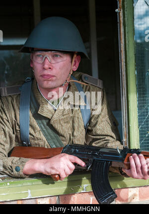 An airsoft player wearing East German, 1975, Junior Non-Commissioned  Officers uniform with an AK-47 automatic assault rifle, The Kalashnikov  Stock Photo - Alamy