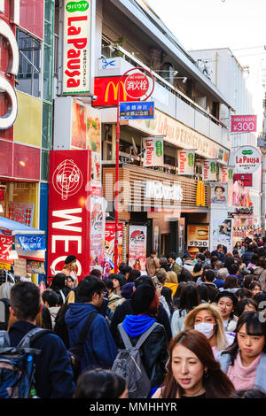 Tokyo, Harajuku. View along Takeshita street, with McDonalds restaurant and other shops and stores, street crowded with shoppers in winter sunshine. Stock Photo