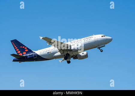 Airbus A319-111, narrow-body, commercial passenger twin-engine jet airliner from Belgian Brussels Airlines in flight against blue sky Stock Photo