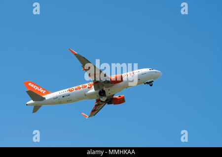 Airbus A320-214 WL, commercial passenger twin-engine jet airliner from British low-cost carrier airline EasyJet in flight against blue sky