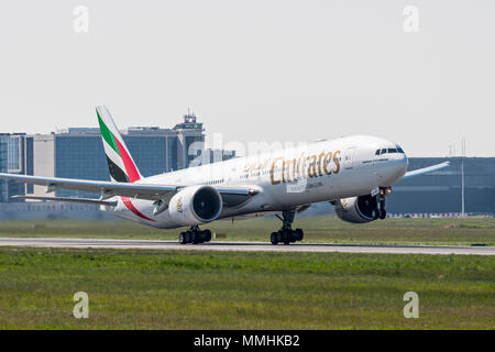 Boeing 777-300ER, long-range wide-body twin-engine jet airliner from Emirates, airline based in Dubai, United Arab Emirates taking off from runway Stock Photo