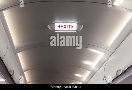 bright nameplate the emergency exits on board an airliner Stock Photo