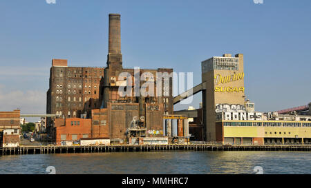 Old Domino Sugar Refinery in Williamsburg viewed from the East River, New York, USA Stock Photo