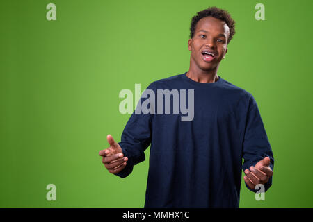 Young African man against green background Stock Photo